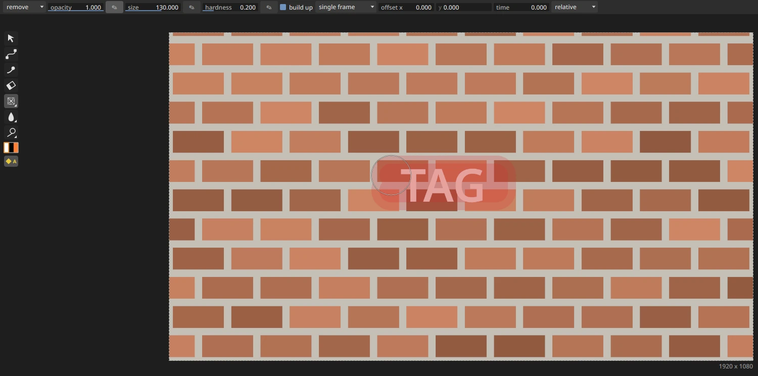 The viewer during a remove stroke: a translucent red band over the word TAG on a brick wall, the Roto toolbar on the left and the brush settings row above with "remove" picked